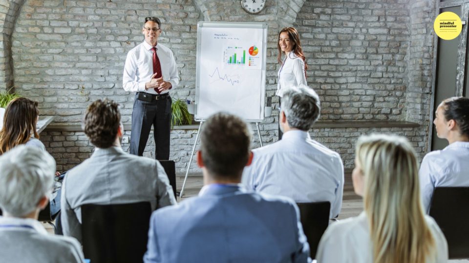 man and woman presenting to a group