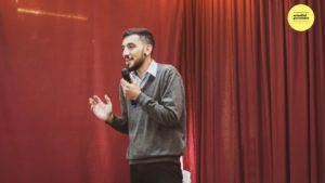 Man with microwave on stage