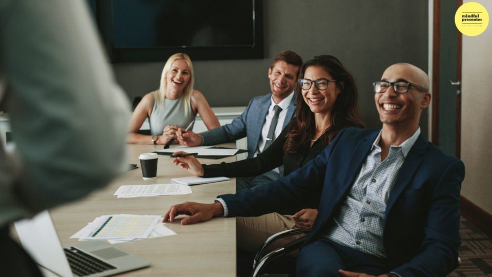 people smiling in a meeting room