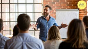 man speaking with flip chart