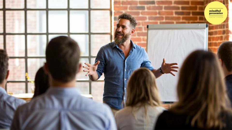 man speaking with flip chart