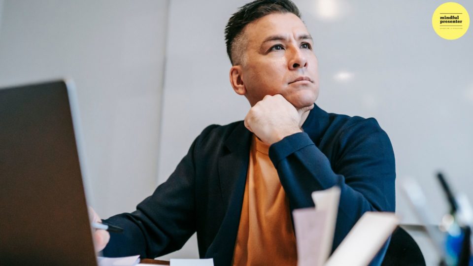 Man sitting with laptop deep in thought