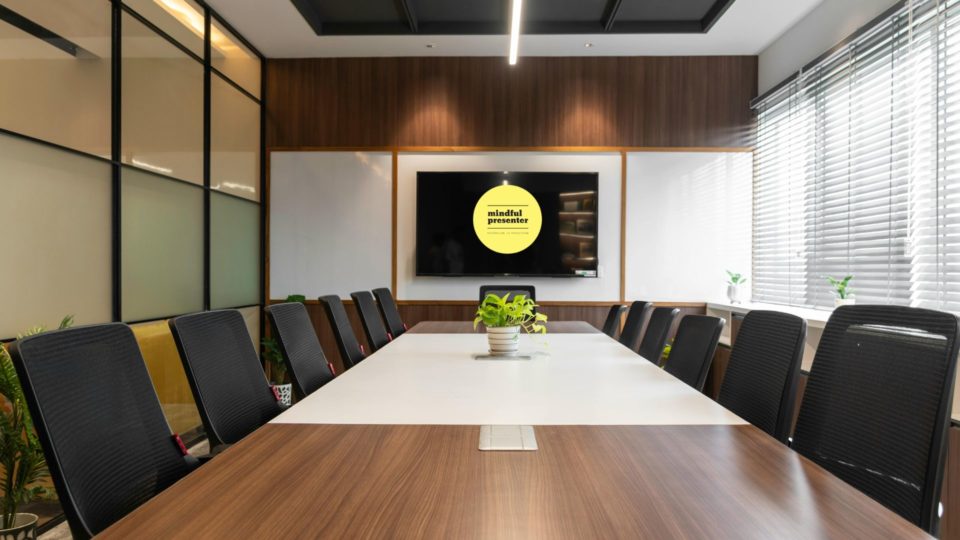 Boardroom with mindful presenter on logo